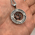 Cable Ring Star of David pendant held in an open palm