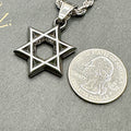 Blackened Star of David pendant beside a US quarter for size, about 26mm across