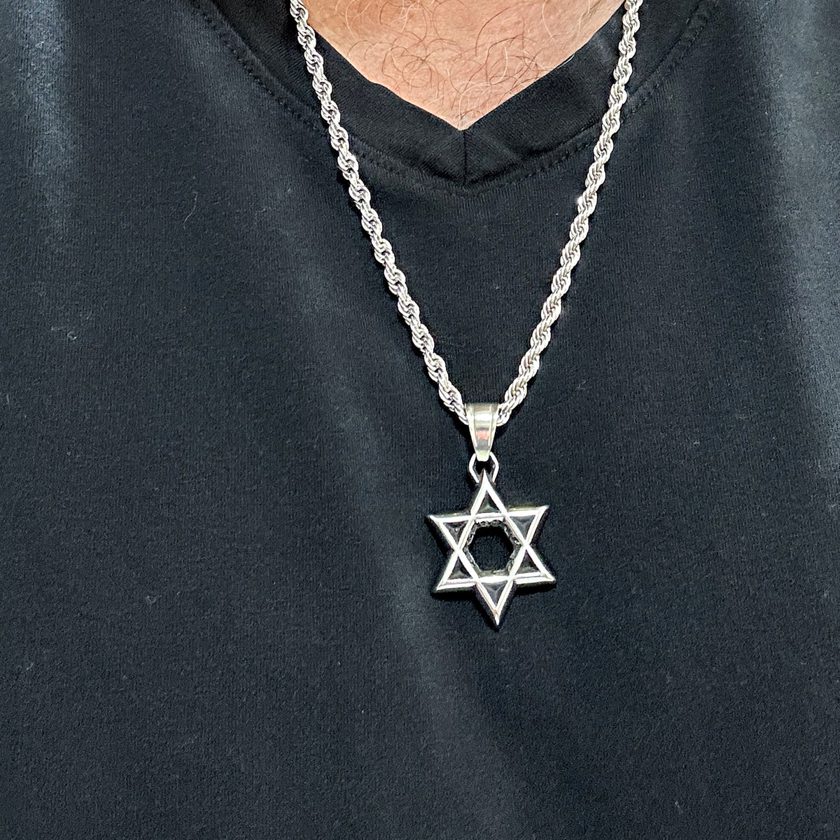 Blackened Star of David necklace worn mid-chest on a 24 inch 4mm rope chain