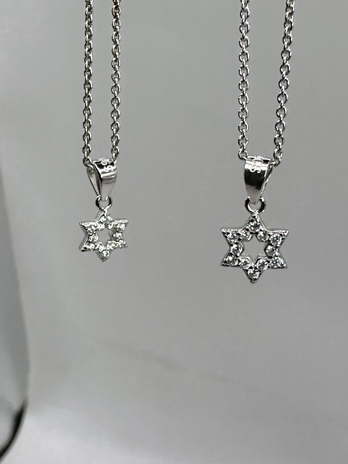 Small and large dainty pavé Star of David necklaces in 925 sterling silver