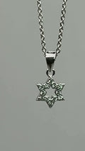 Dainty pavé Star of David pendant in 925 sterling silver turning on its chain